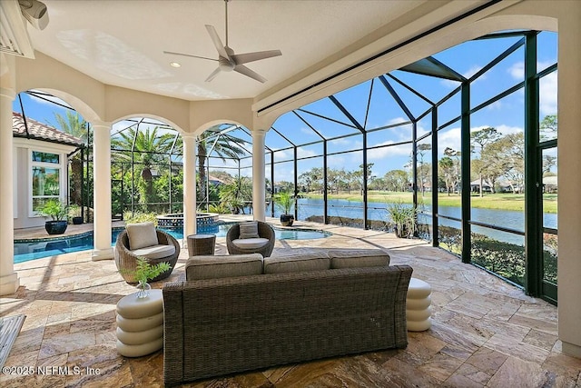 view of patio / terrace featuring a lanai and a water view