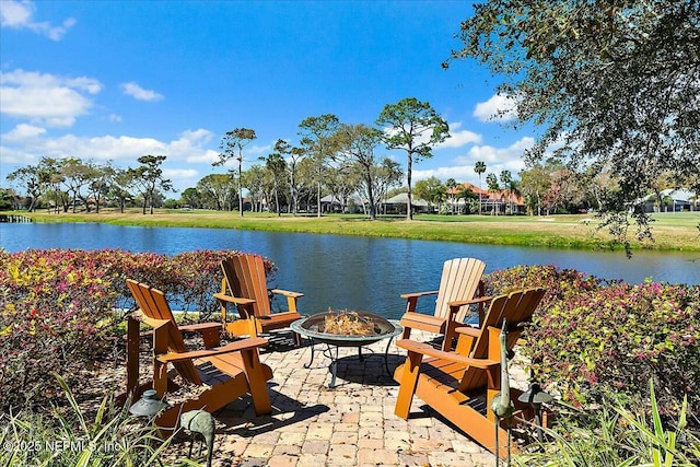 view of patio / terrace with a water view and an outdoor fire pit