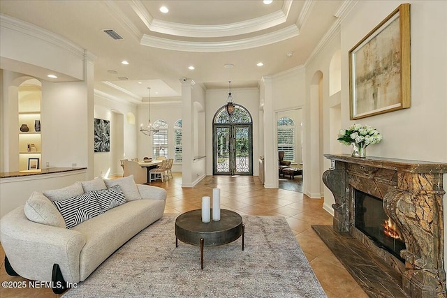 living room with visible vents, light tile patterned floors, recessed lighting, a fireplace, and a raised ceiling