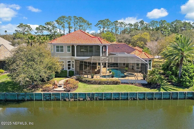 back of property featuring a water view, a tile roof, a patio, a fenced in pool, and a lanai