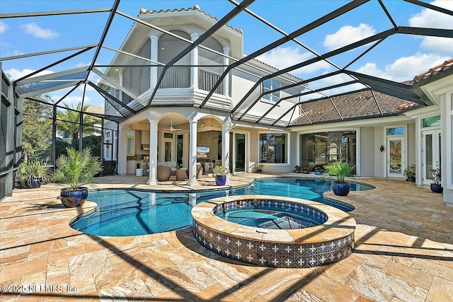 view of swimming pool with a lanai, a patio area, and a pool with connected hot tub