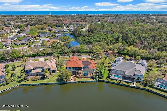 birds eye view of property with a residential view and a water view