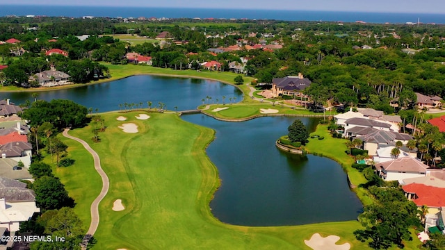 birds eye view of property with a residential view, a water view, and view of golf course