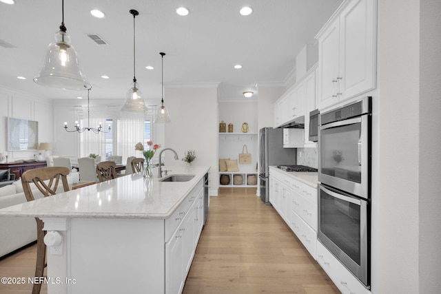 88 Village Grande Dr, Ponte Vedra, FL 32081 - kitchen featuring a kitchen bar, visible vents, ornamental molding, a sink, and stainless steel appliances