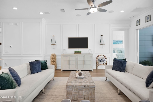 88 Village Grande Dr, Ponte Vedra, FL 32081 - living room with light wood finished floors, visible vents, crown molding, a decorative wall, and a ceiling fan