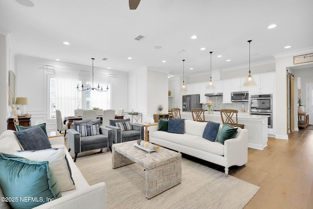 88 Village Grande Dr, Ponte Vedra, FL 32081 - living room with light wood finished floors, visible vents, a chandelier, ornamental molding, and recessed lighting