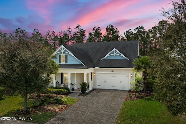 88 Village Grande Dr, Ponte Vedra, FL 32081 - view of front of house featuring a porch, decorative driveway, a front lawn, and an attached garage