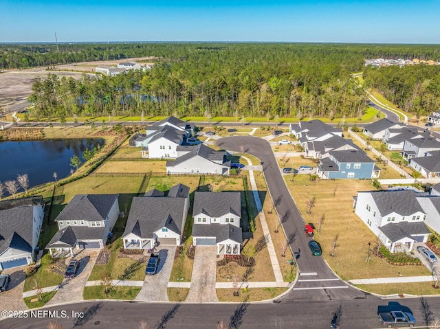 birds eye view of property featuring a residential view, a water view, and a view of trees