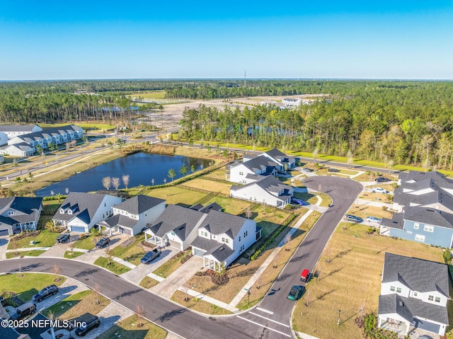 aerial view featuring a water view, a wooded view, and a residential view