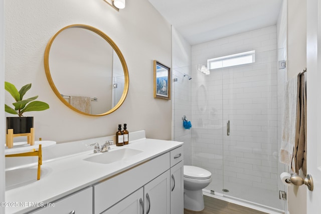 full bath with a shower stall, toilet, and vanity