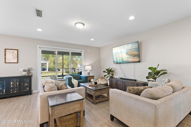 living room featuring recessed lighting, visible vents, and light wood-style floors