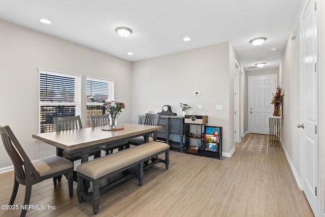 dining space featuring light wood-style flooring, baseboards, and recessed lighting