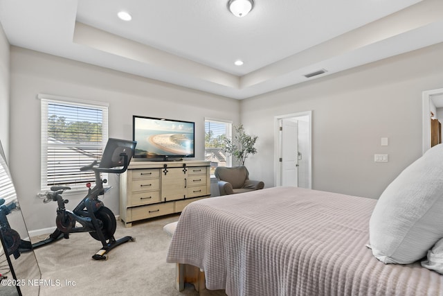 bedroom with baseboards, multiple windows, light colored carpet, and visible vents