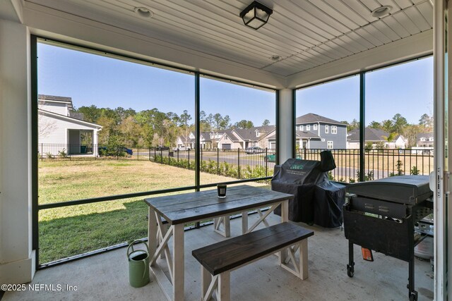 sunroom / solarium featuring a residential view