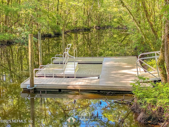 view of dock featuring a wooded view
