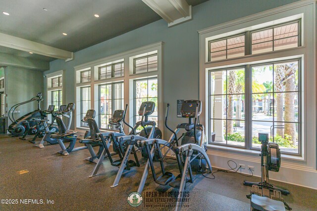 gym with baseboards, a healthy amount of sunlight, and recessed lighting