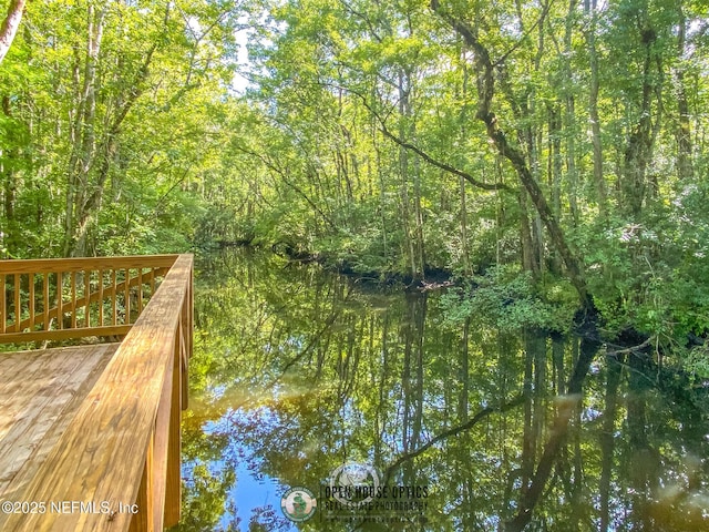 view of dock featuring a forest view