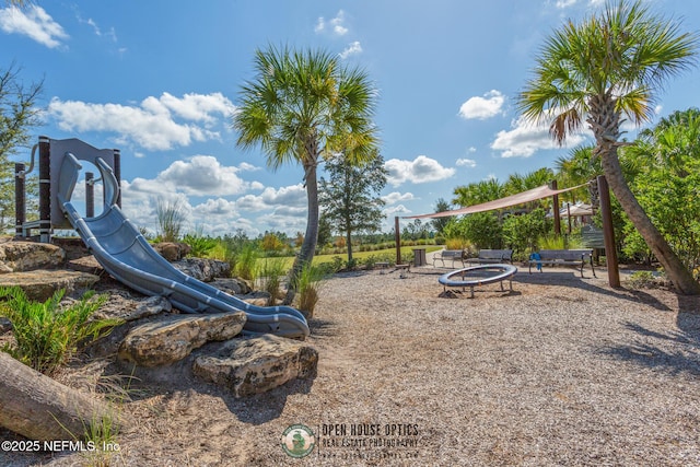 view of playground with a fire pit