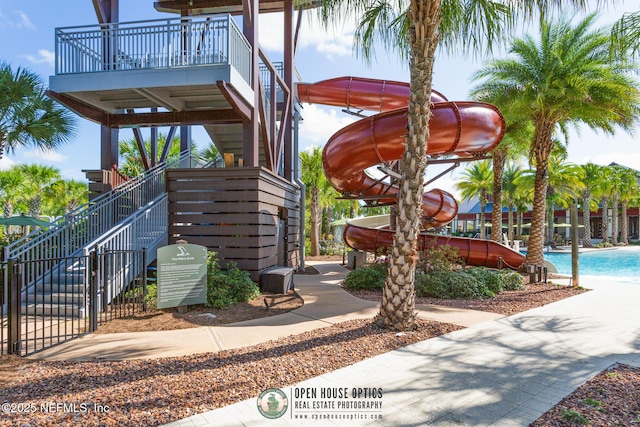surrounding community featuring stairs and a pool