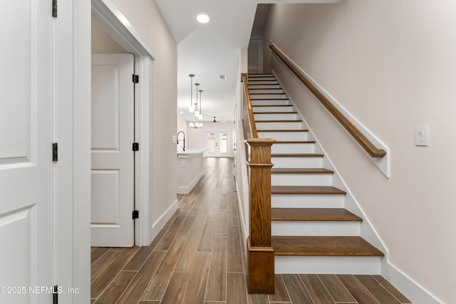 stairs featuring recessed lighting, baseboards, and wood finish floors