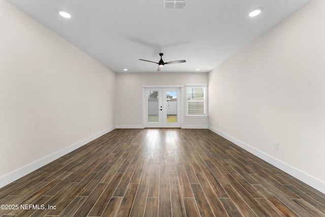 spare room featuring dark wood-type flooring, french doors, visible vents, and ceiling fan