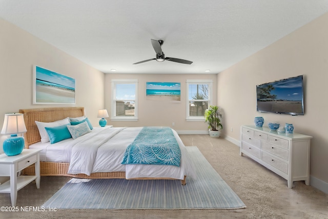 bedroom featuring ceiling fan, carpet, and baseboards