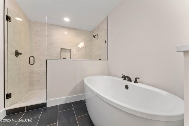 bathroom with tile patterned floors, a soaking tub, recessed lighting, and a shower stall