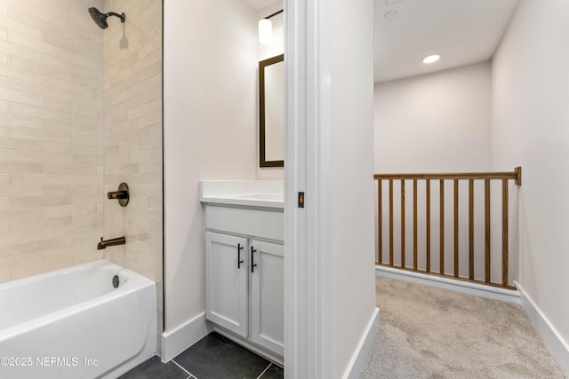 bathroom featuring vanity,  shower combination, baseboards, and tile patterned floors