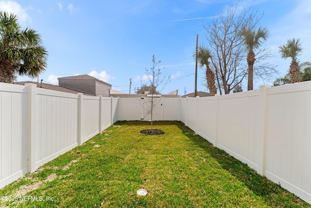 view of yard with a fenced backyard