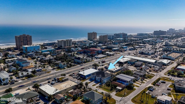 drone / aerial view with a city view and a water view