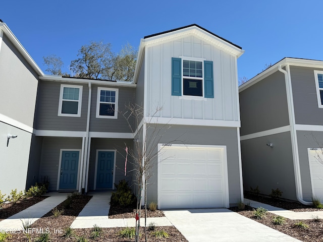 view of front of home featuring board and batten siding, concrete driveway, and an attached garage