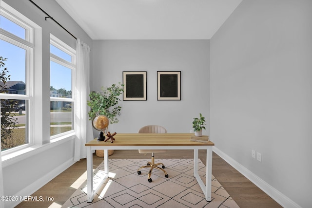 office space with wood finished floors and baseboards