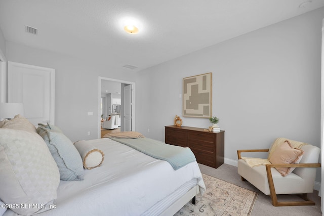 bedroom with visible vents, baseboards, and carpet