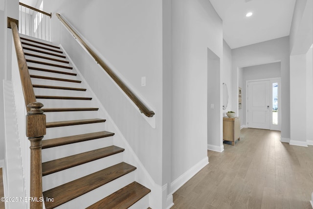 stairs featuring recessed lighting, baseboards, and wood finished floors