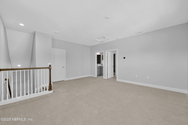 empty room featuring light carpet, recessed lighting, and baseboards