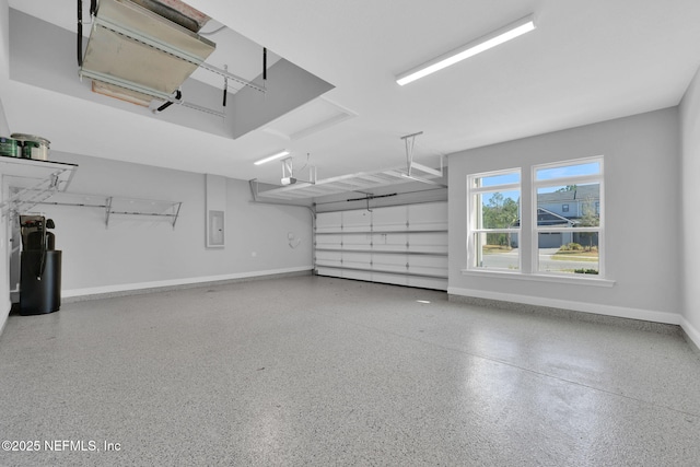 garage with electric panel, baseboards, and a garage door opener