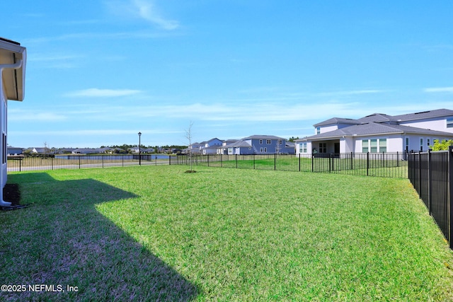 view of yard with a residential view and a fenced backyard