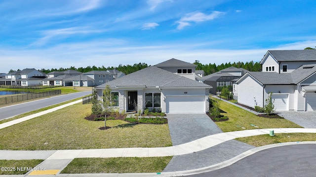 view of front of property with a residential view, a garage, decorative driveway, and a front lawn