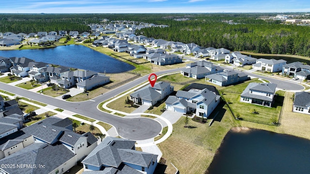 bird's eye view featuring a residential view and a water view