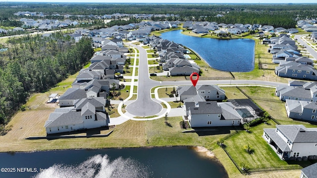 drone / aerial view with a residential view and a water view