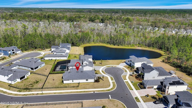 bird's eye view with a wooded view, a water view, and a residential view