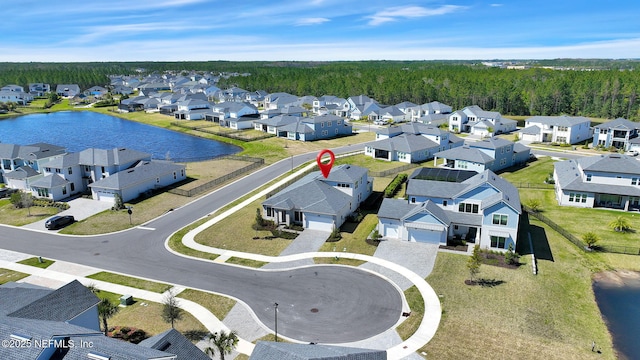 drone / aerial view featuring a residential view and a water view