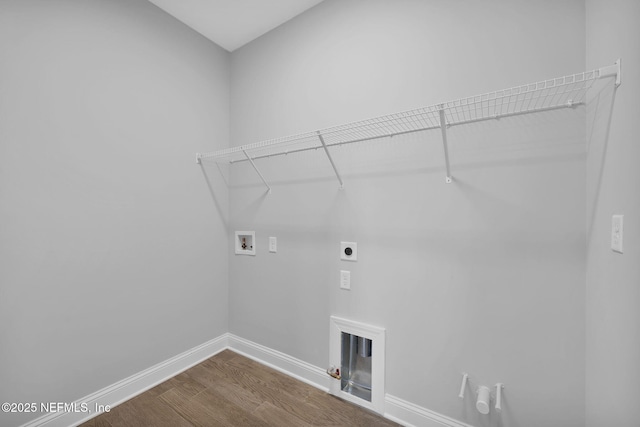 clothes washing area with baseboards, washer hookup, laundry area, hookup for an electric dryer, and dark wood-style flooring