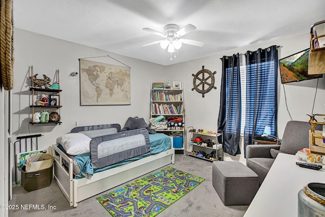 bedroom featuring a ceiling fan and a textured ceiling