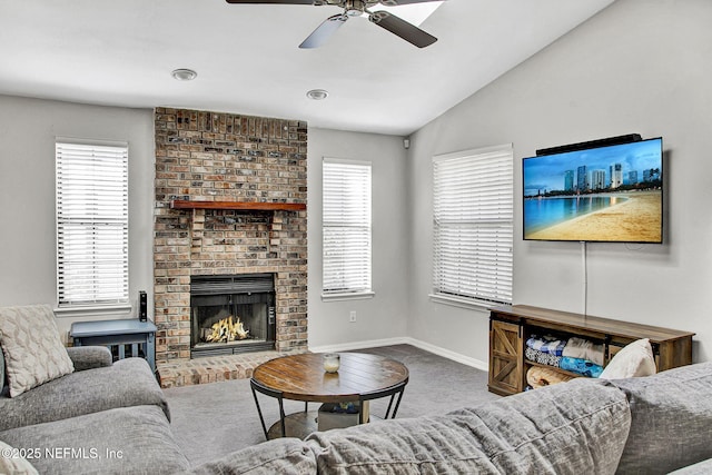 carpeted living room with a wealth of natural light, baseboards, lofted ceiling, and ceiling fan