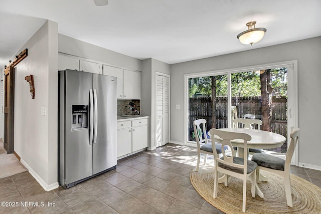 tiled dining room with baseboards