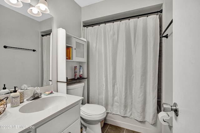 bathroom with vanity, tile patterned floors, shower / tub combo, and toilet