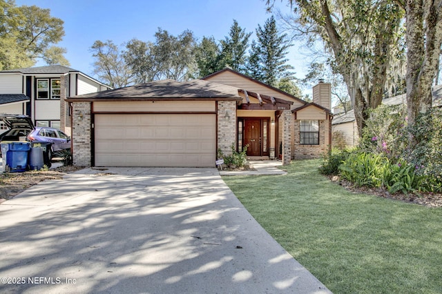 view of front of property featuring driveway, a front yard, a garage, brick siding, and a chimney