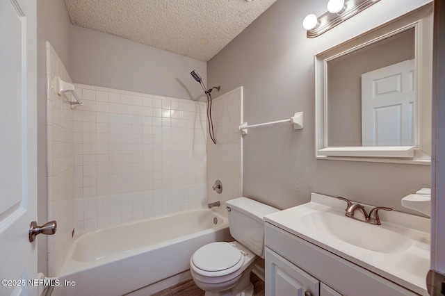 bathroom with a textured ceiling,  shower combination, vanity, and toilet