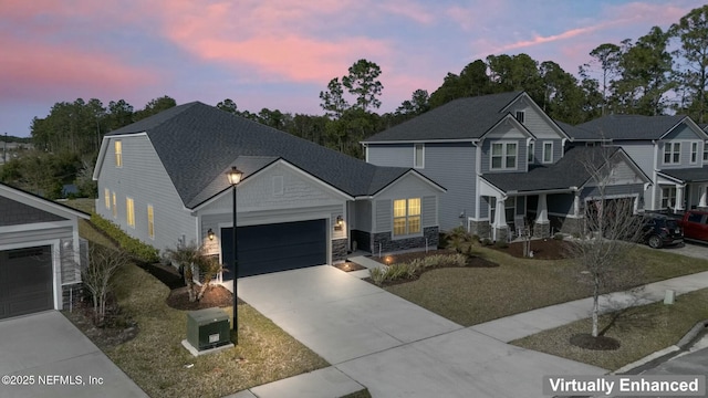 view of front facade with concrete driveway, an attached garage, and stone siding